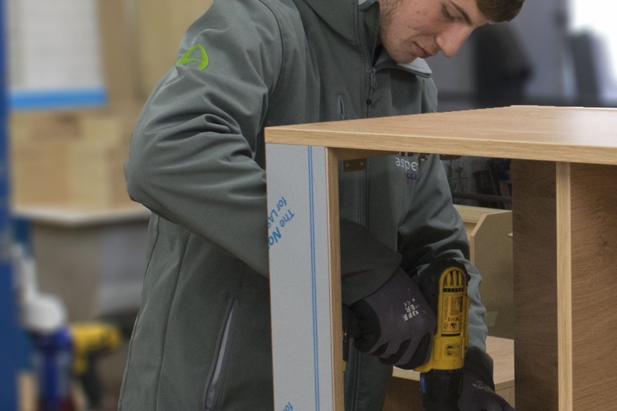 Aspen Concepts apprentice fixing a screw