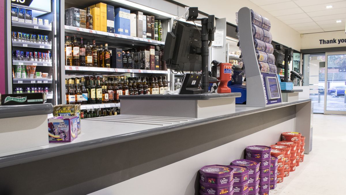 supermarket cash till desk and back line shelving manufactured by Aspen Concepts